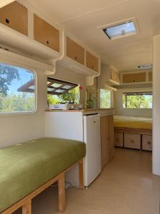 an interior view of a kitchen in a tiny house at Chic vintage caravan retreat, just 25 mins to the beach in Odeceixe