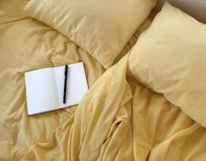 a book sitting on top of a bed at Chic vintage caravan retreat, just 25 mins to the beach in Odeceixe +16 photos