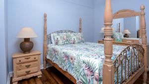 a bedroom with a bed and a night stand with a lamp at 409 Mariners Club in Key Largo +37 photos