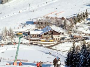 a ski resort with a ski lift in the snow at Apartment Simonhöhe Veitsberg by Interhome in Sankt Paul