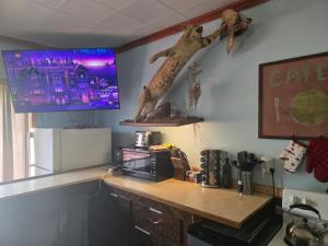a kitchen with a desk and a tv on the wall at Jake's Bed & Bar in Toivola +7 photos