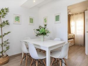 a white dining room with a white table and white chairs at Apartment Oasis Cambrils by Interhome in Cambrils +17 photos