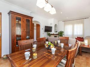 a dining room and living room with a wooden table at Holiday Home Villa Meli by Interhome in Vidreres