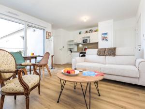 a living room with a couch and a table at Apartment Colette by Interhome in Saint-Coulomb +8 photos
