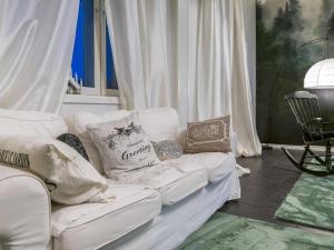 a white couch with pillows on it in a room at Holiday Home Vilppulan huvila by Interhome in Suluslahti