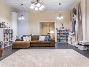 a living room with a brown couch and bookshelves at Holiday Home Vilppulan huvila by Interhome in Suluslahti