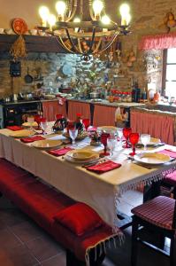 a long table with a white table cloth on it at Villa de Fujacos in Valença +81 photos