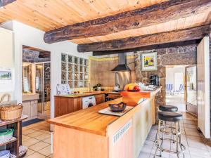 a kitchen with wooden ceilings and a counter top at Holiday Home Ty-2-Go by Interhome in Trégunc