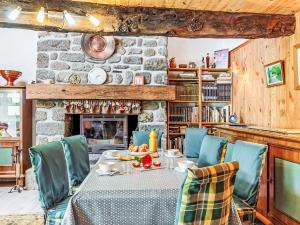 a dining room with a table and chairs and a fireplace at Holiday Home Ty-2-Go by Interhome in Trégunc +14 photos