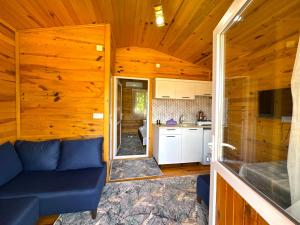 a living room with a blue couch in a cabin at Venüs Gold Bungalov Adrasan in Kumluca