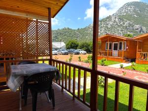 a porch with a table and a view of a house at Venüs Gold Bungalov Adrasan in Kumluca