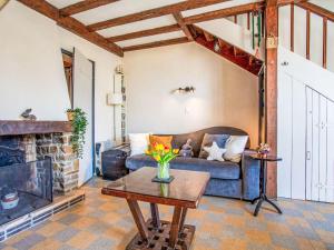 a living room with a couch and a fireplace at Holiday Home Ker Lann by Interhome in La Bernerie-en-Retz