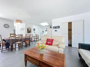 a living room with a couch and a table at Holiday Home Les Embruns by Interhome in La Bernerie-en-Retz