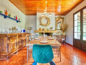 a dining room with a wooden table and chairs at Holiday Home La Sablière by Interhome in Lanton