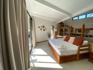 a bedroom with a bed and a large window at Mar Botánico - Avellanas Beach Hotel in Playa Avellana