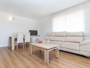 a living room with a couch and a table at Holiday Home Refuge de la Mer by Interhome in Cunit +28 photos