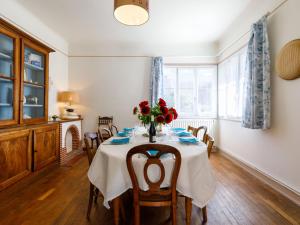 a dining room with a table with a vase of flowers at Holiday Home Charme de la Plage de Port Lin by Interhome in Le Croisic