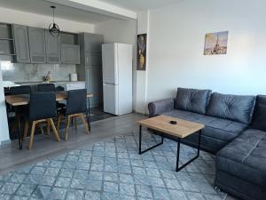 a living room with a couch and a table at Stan na dan - apartman Lara in Pale