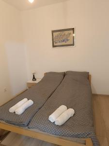 a bed with two white pillows on it at Stan na dan - apartman Lara in Pale