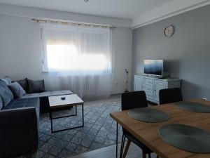 a living room with a couch and a table at Stan na dan - apartman Lara in Pale