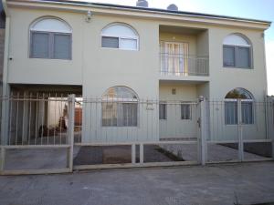 une maison blanche avec une clôture devant dans l'établissement Villa Corsina, à Colón