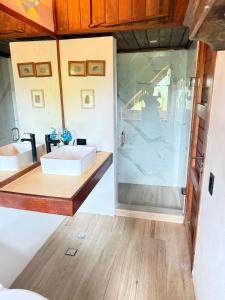 a bathroom with a sink and a shower at Villa EL Retiro in La Luisa +8 photos