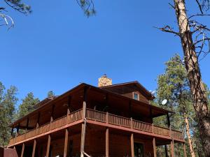 a large wooden house with a wrap around deck at Your Mountain Retreat in Loveland