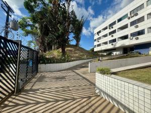 a sidewalk next to a building with a fence at (103) Beach Garden na praia da litorânea in Pimenta
