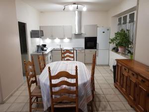 a kitchen with a table and chairs in a room at Charmant Duplex avec Jardin Privatif et Parking, à Proximité de Montargis et Pithiviers - FR-1-590-194 in Lorcy