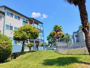a house with a fence and palm trees at 1 bedroom in 3 BR condo in Tukwila