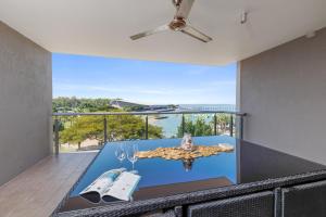 a dining room with a view of the ocean at Delightful Waterfront Lagoon Views & Restaurants in Darwin