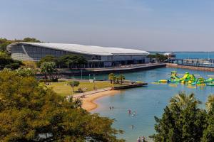a group of people in the water at a water park at Delightful Waterfront Lagoon Views & Restaurants in Darwin