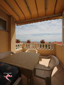 a table and chairs on a balcony with a view at Apartments Vila&Zora in Vodice