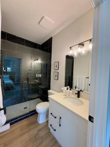 a bathroom with a shower and a sink and a toilet at The Lamp House in Nordegg +19 photos