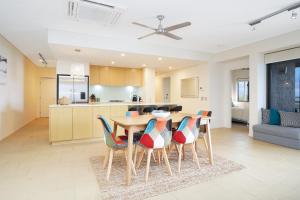 a kitchen and dining room with a table and chairs at Picturesque Waterfront Lagoon Views Top Lvl & BBQ in Darwin