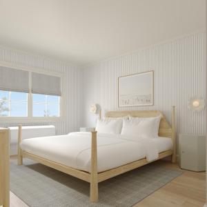 a white bedroom with a large bed with white pillows at Bay Shores Peninsula Hotel in Newport Beach