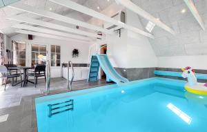 a pool with a slide in a house at Pet Friendly Home In Ringkøbing in Klegod
