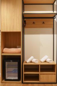 a closet with wooden cabinets and a fireplace at Hotel Relax City Center in Tirana +80 photos