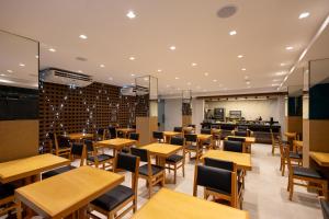 a dining room with wooden tables and chairs at Aira Hotel in Sobral