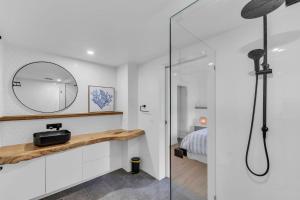 a bathroom with a shower and a mirror at Bellvilla - Bluebonnet Suite in Merimbula +4 photos