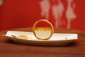a plate with a half eaten egg on a table at Sunset INN by Pro-Ema in Dili