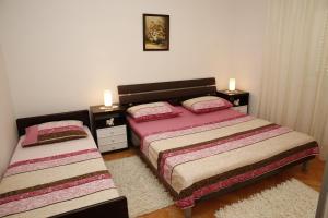 a bedroom with two beds and two night stands at Apartments Vila&Zora in Vodice