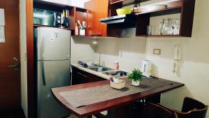 a small kitchen with a sink and a refrigerator at Departamentos Home Bulnes in Santiago +40 photos