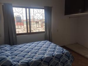 a bedroom with a bed in front of a window at Nuevo departamento en el centro de Coatepec in Coatepec