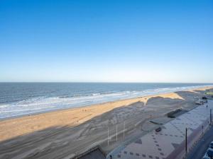 a view of a beach with the ocean at Family Home near Beach in Golden Triangle in Knokke-Heist