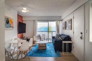 a living room with a couch and a table and chairs at Okanagan Lakefront Resort in Penticton