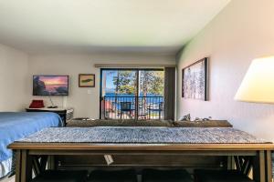 a bedroom with a bed and a balcony at 244 Bldg C condo in Truckee
