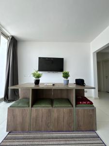 a living room with a table with a tv on it at Chalet 3 bedrooms in Fouka Bay in Marsa Matruh