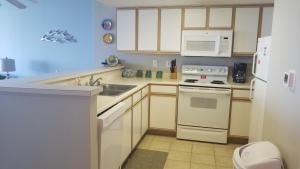 a kitchen with white appliances and a white microwave at Gorgeous Oceanfront 3 Bedrooms Condo Sleeps up to10 people - Initial supply of Linens Included in Myrtle Beach
