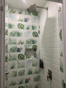 a bathroom with a shower with green plants on the wall at Kasa Boutique Hotel in Cebu City